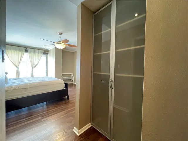 a view of a hallway with wooden floor and staircase