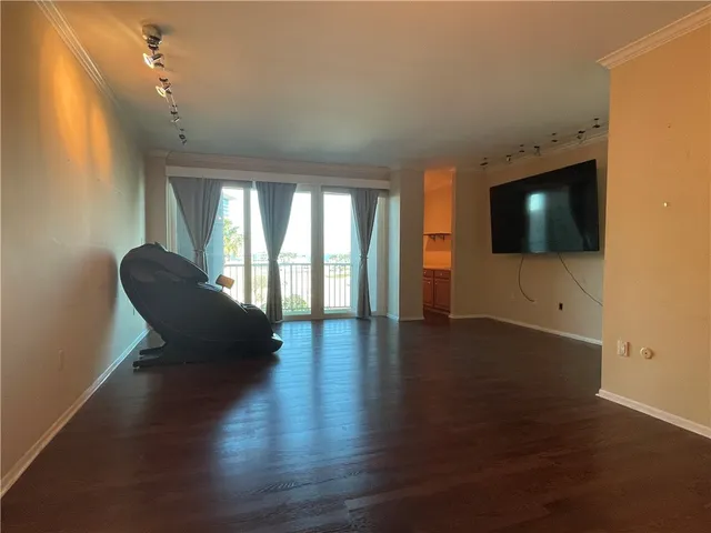 a kitchen with a chandelier and wooden floors