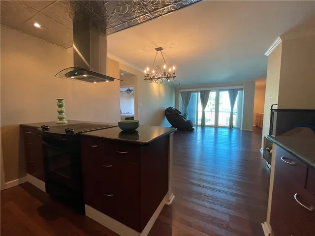 a view of a livingroom with wooden floor and a flat screen tv