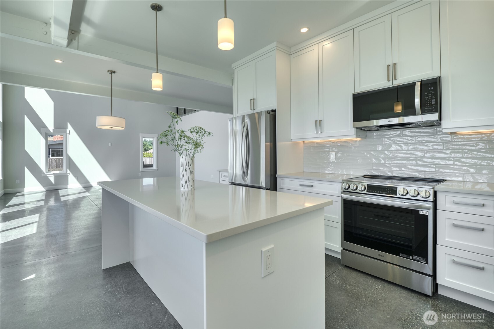 631 Freemans Lane Point Roberts, WA 98281 - Photo 14 of 40 a kitchen with stainless steel appliances a stove microwave and cabinets