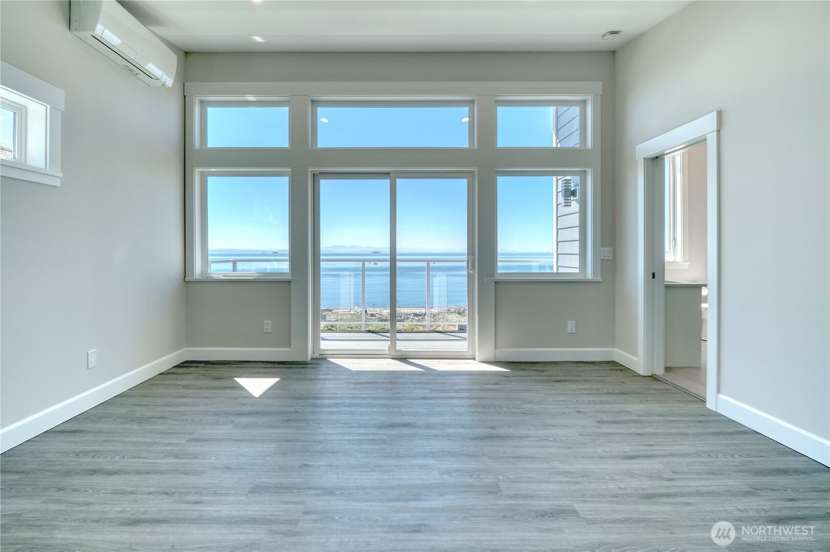 631 Freemans Lane Point Roberts, WA 98281 - Photo 19 of 40 a view of an empty room with wooden floor and a window