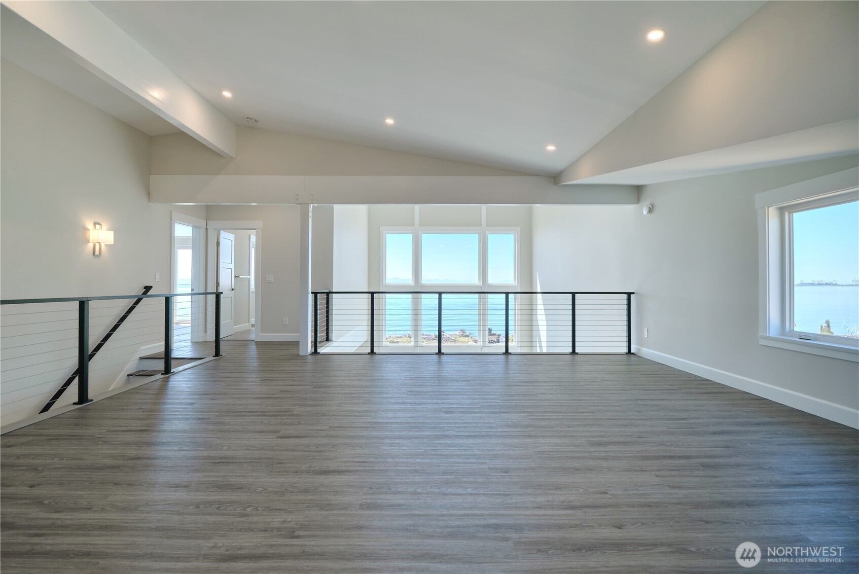 631 Freemans Lane Point Roberts, WA 98281 - Photo 27 of 40 a view of an empty room with wooden floor and windows