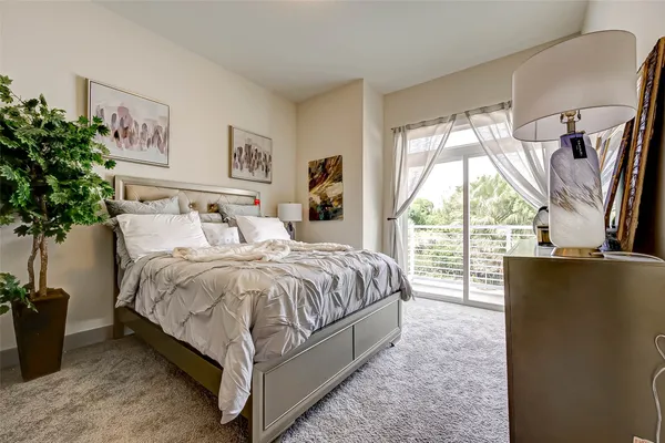 a bed sitting in a bedroom next to a window
