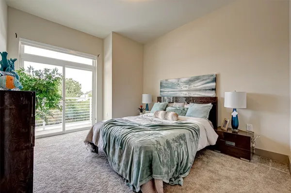 a bed sitting in a bedroom next to a window