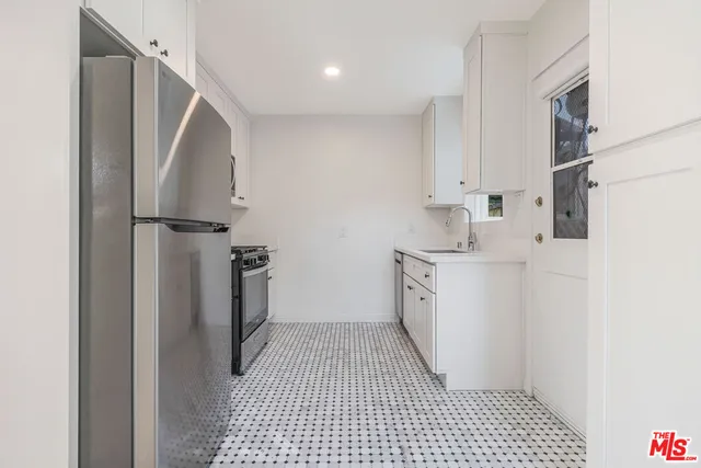 a bathroom with a sink a toilet and a shower