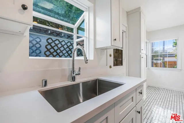 a kitchen with a sink and cabinets