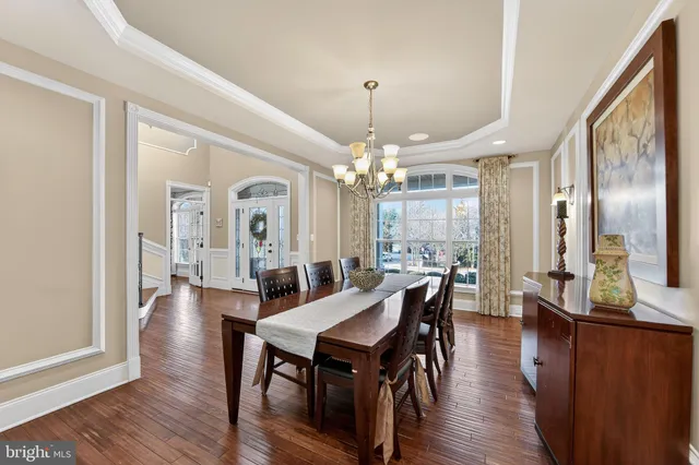 a kitchen with stainless steel appliances granite countertop a sink and cabinets with wooden floor