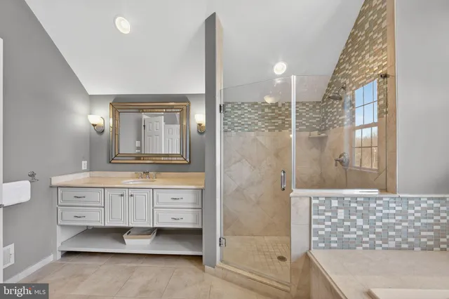 a living room with furniture a large window and wooden floors