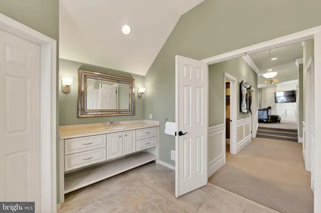 a living room with furniture a flat screen tv and a large window