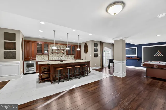 an aerial view of a house with swimming pool and a yard