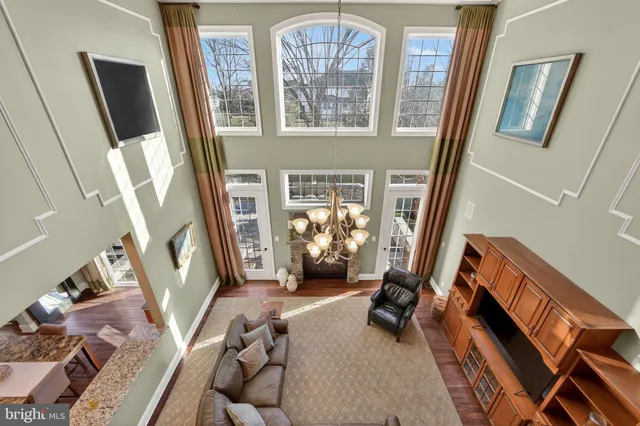 a view of a a dining room with furniture window and wooden floor