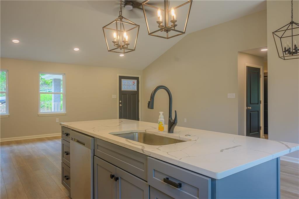 2392 Ridge Rd Extension Ambridge, PA 15003 - Photo 24 of 37 a kitchen with a sink a chandelier and wooden floor