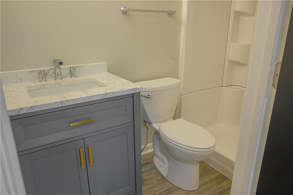 2392 Ridge Rd Extension Ambridge, PA 15003 - Photo 32 of 37 a bathroom with a granite countertop toilet and a sink