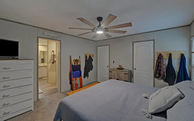 a bedroom with a bed and a chandelier