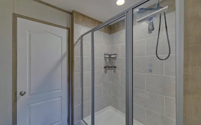 a bathroom with a toilet and a mirror