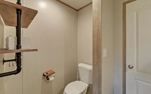 en empty room with windows and fireplace