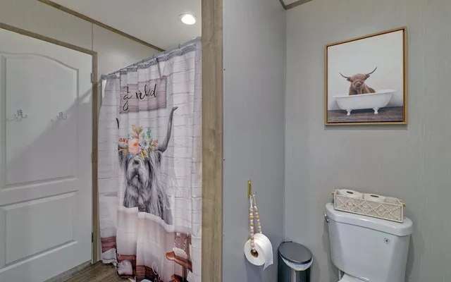 a bedroom with a bed a chair and table