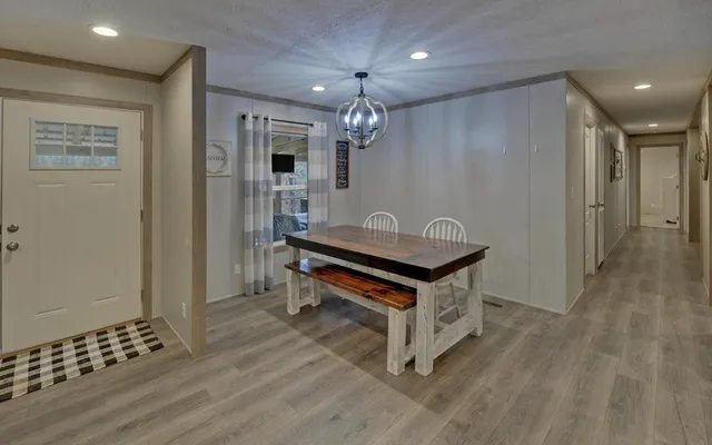 a view of a dining room with furniture wooden floor and chandelier