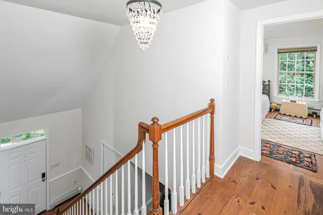 a view of a hallway to a livingroom with furniture