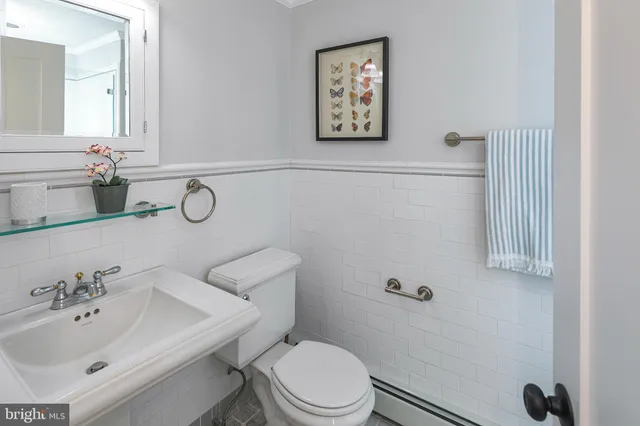 a bathroom with a sink mirror and toilet