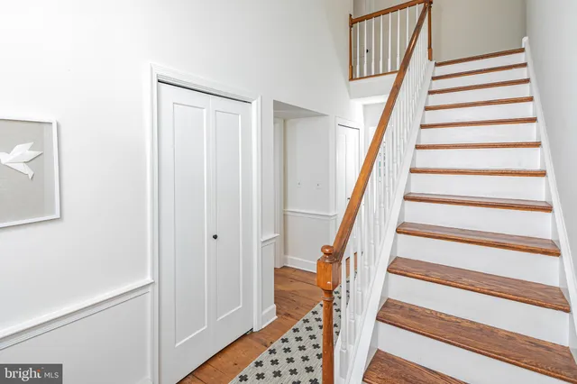 a view of entryway with wooden floor and stairs