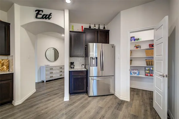 a kitchen with stainless steel appliances a refrigerator sink and cabinets