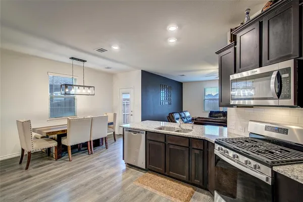 a kitchen with a stove and a wooden floors