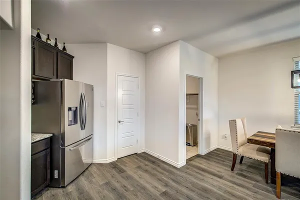 a kitchen with stainless steel appliances a refrigerator and a stove top oven