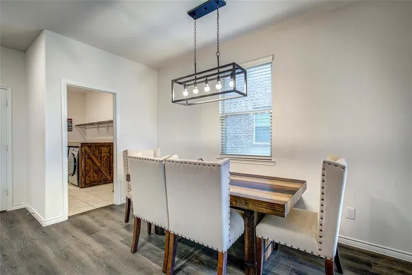 a view of a dining room with furniture wooden floor and a chandelier