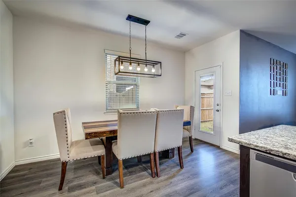 a view of a dining room with furniture wooden floor and chandelier