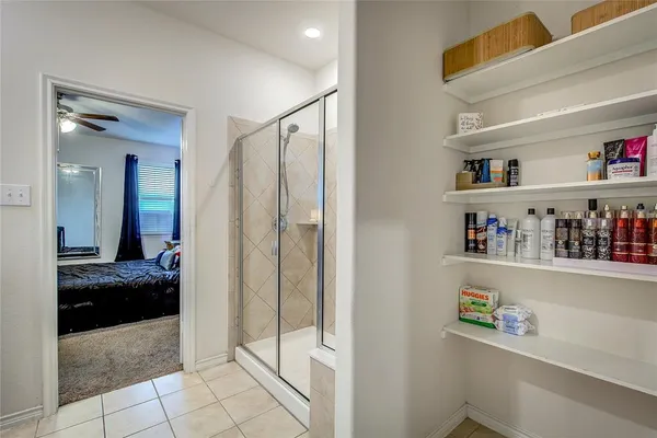 a view of walk in closet with clothes