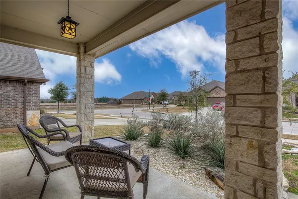 a view of a balcony with furniture
