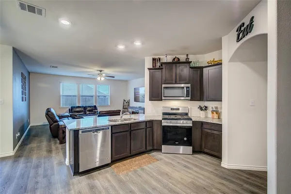 a kitchen with cabinets a sink and appliances