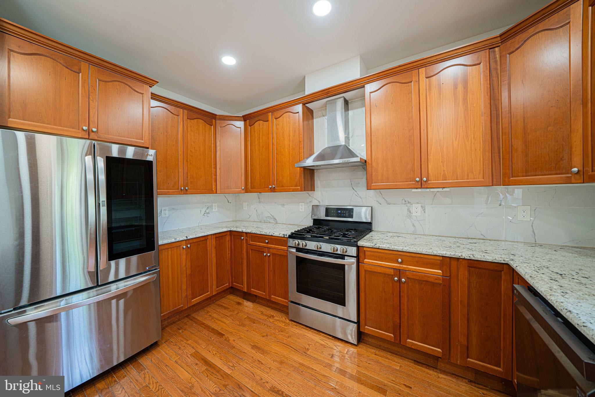 54 Arbor Circle Colmar, PA 18915 - Photo 16 of 74 a kitchen with stainless steel appliances granite countertop a stove a sink and a refrigerator