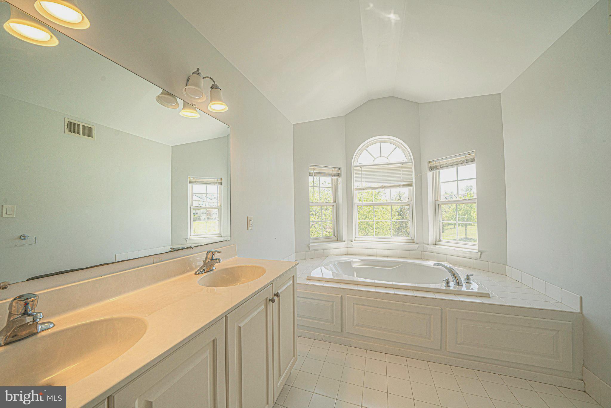 54 Arbor Circle Colmar, PA 18915 - Photo 40 of 74 a spacious bathroom with a granite countertop tub sink and mirror