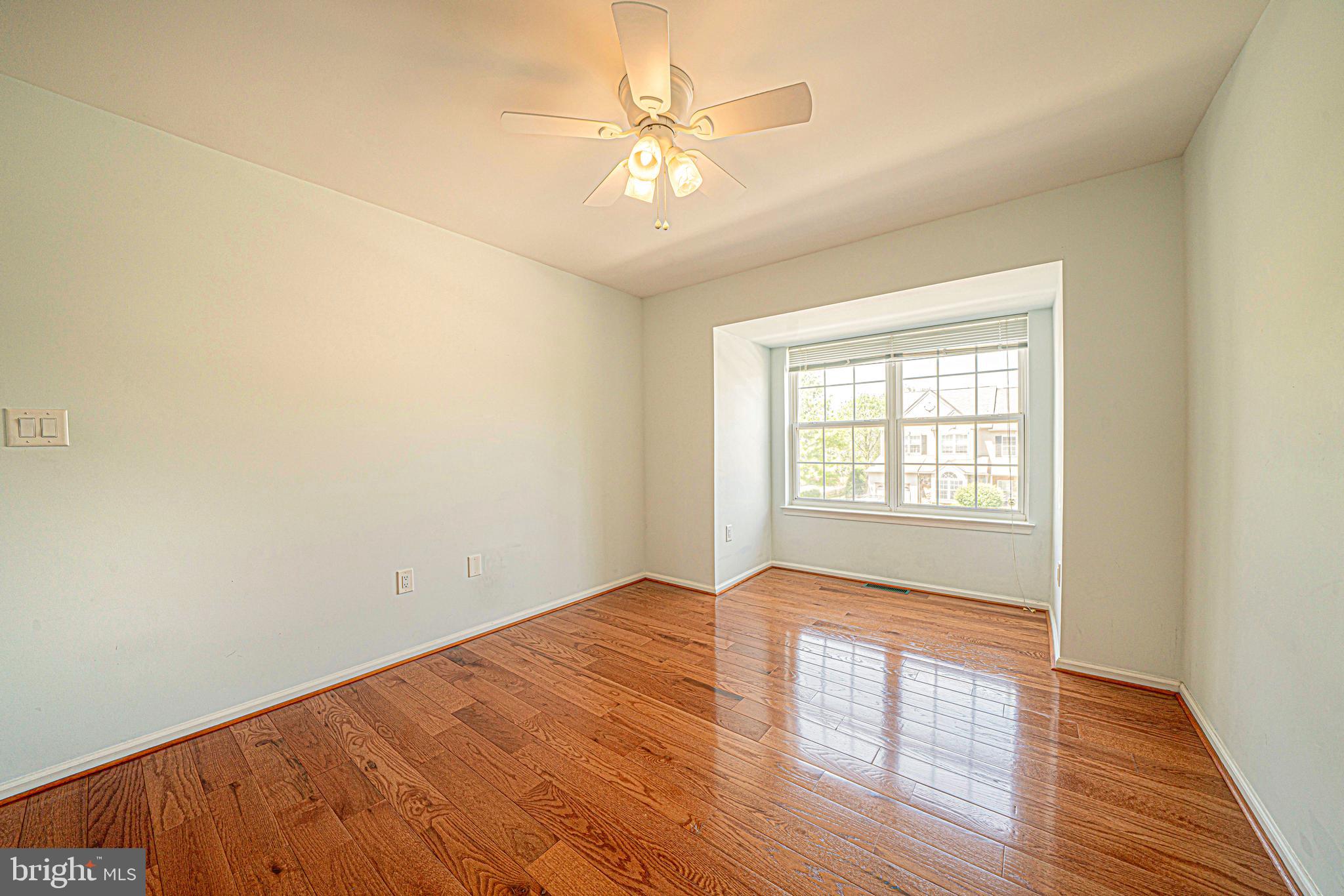 54 Arbor Circle Colmar, PA 18915 - Photo 47 of 74 an empty room with wooden floor fan and windows