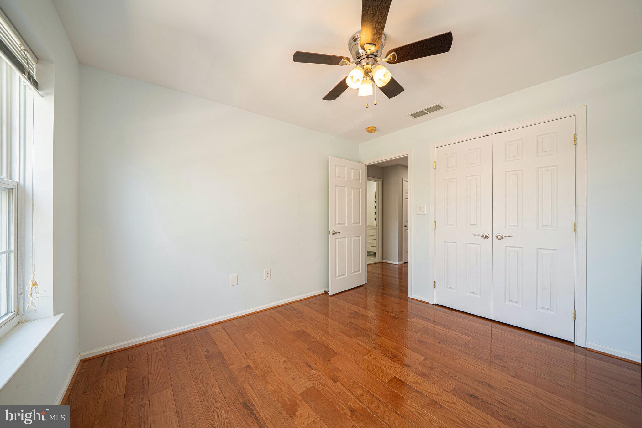 54 Arbor Circle Colmar, PA 18915 - Photo 56 of 74 an empty room with wooden floor fan and windows