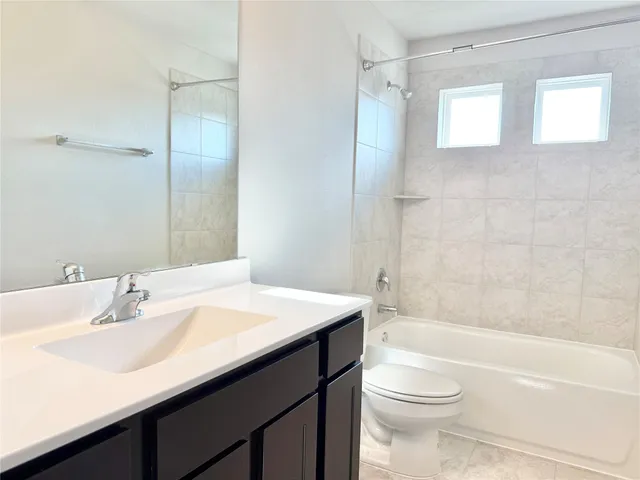 a bathroom with a sink a toilet and a bathtub