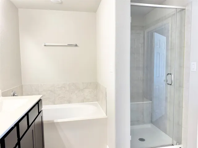 a bathroom with a bathtub and a sink