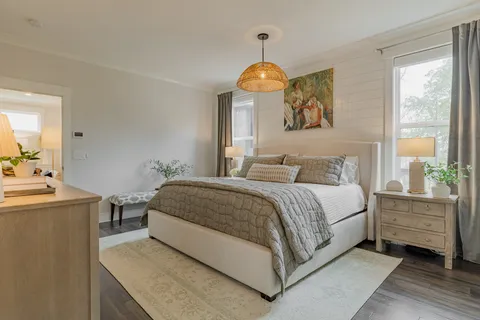 a bedroom with a bed and a chandelier