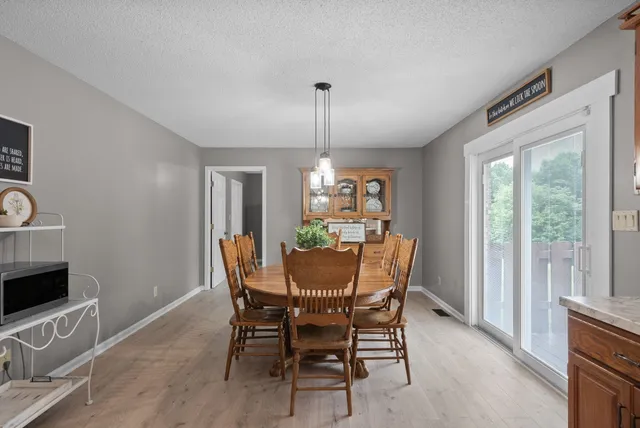 a view of a dining room with furniture window and outside view