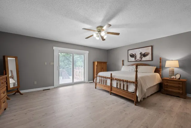 a spacious bedroom with a bed and a chandelier