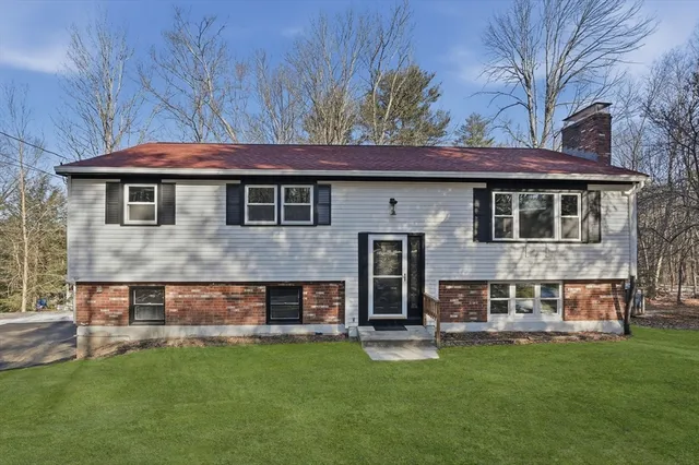 a front view of a house with a garden and deck