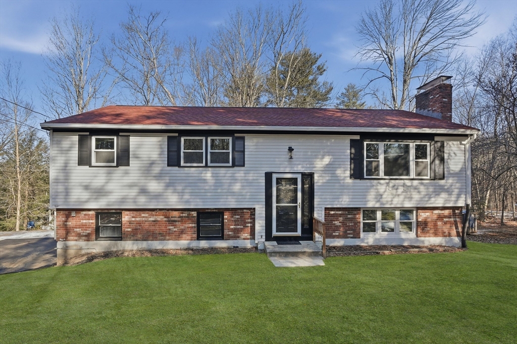 a front view of a house with a garden and deck