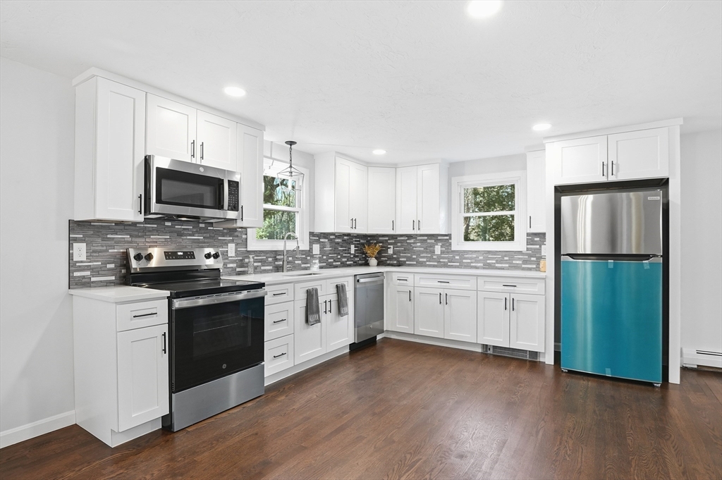 2 Laurel Lane Spencer, MA 01562 - Photo 12 of 42 a kitchen with granite countertop a refrigerator stove top oven and sink