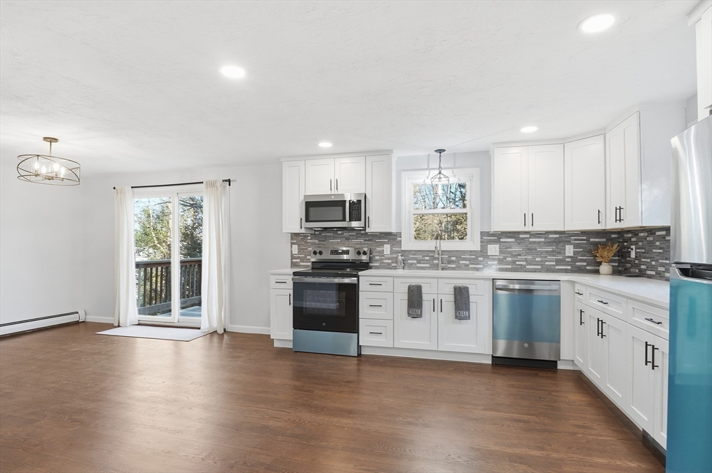 2 Laurel Lane Spencer, MA 01562 - Photo 15 of 42 a kitchen with stainless steel appliances granite countertop a stove top oven a sink and a refrigerator