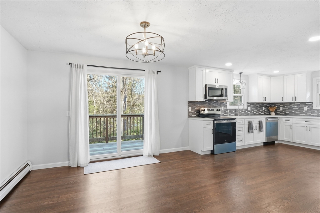 2 Laurel Lane Spencer, MA 01562 - Photo 16 of 42 a kitchen with stainless steel appliances granite countertop a stove top oven a sink and a chandelier