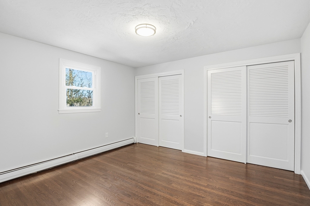2 Laurel Lane Spencer, MA 01562 - Photo 18 of 42 an empty room with wooden floor and windows