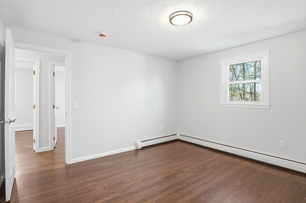 2 Laurel Lane Spencer, MA 01562 - Photo 19 of 42 an empty room with wooden floor and windows