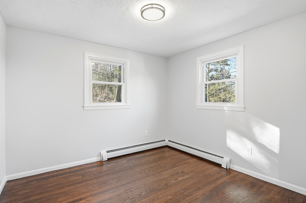 2 Laurel Lane Spencer, MA 01562 - Photo 20 of 42 an empty room with wooden floor and windows